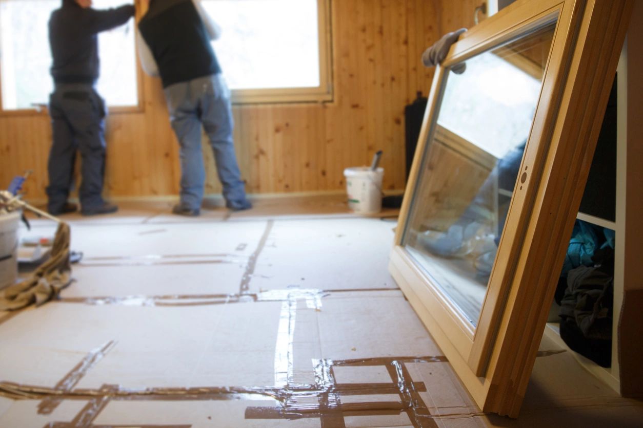 A man standing in front of a window.